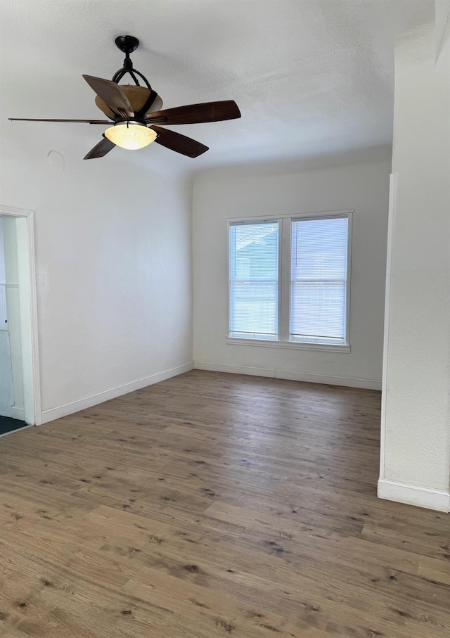 220 S K, Madera, CA 93637 - empty room featuring wood finished floors, baseboards, and ceiling fan