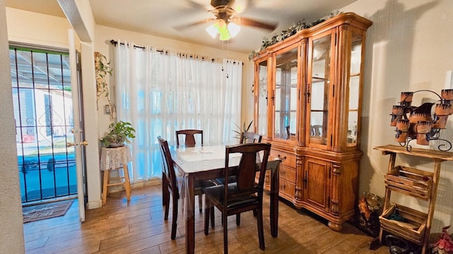 dining space with ceiling fan and hardwood / wood-style floors