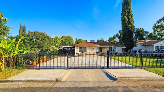 view of front of property featuring a gate, fence private yard, and a front lawn