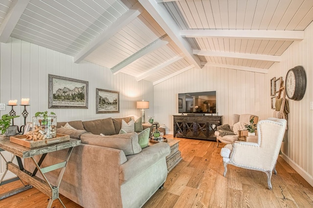 living room featuring hardwood / wood-style floors, wood walls, and vaulted ceiling with beams