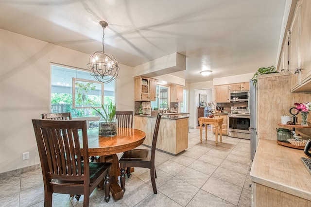 dining room with an inviting chandelier and light tile patterned floors