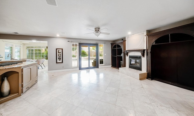 8164 N 8th St, Fresno, CA 93720 - unfurnished living room featuring a ceiling fan, recessed lighting, baseboards, light tile patterned floors, and a glass covered fireplace