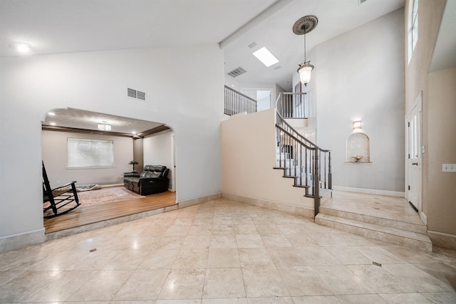 8164 N 8th St, Fresno, CA 93720 - tiled foyer entrance featuring high vaulted ceiling, stairs, arched walkways, and baseboards