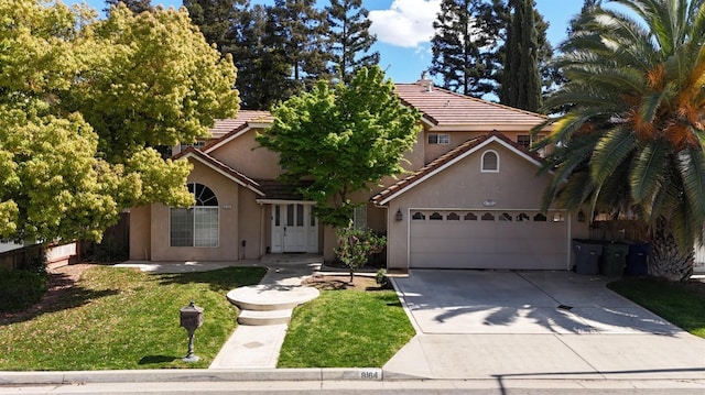 8164 N 8th St, Fresno, CA 93720 - view of property hidden behind natural elements with a tiled roof, stucco siding, concrete driveway, and a front yard