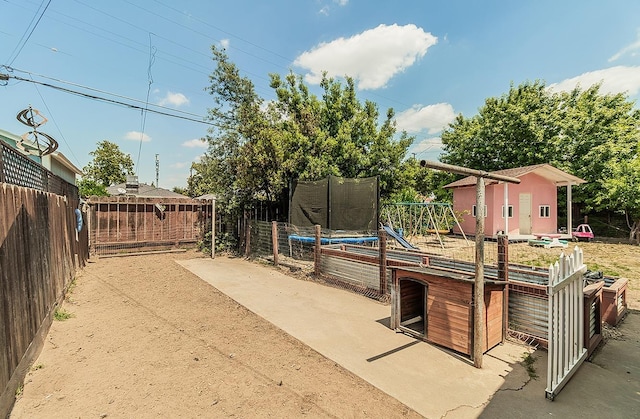 528 W Yale Ave, Fresno, CA 93705 - view of patio / terrace with a trampoline, an outbuilding, fence, and a storage unit