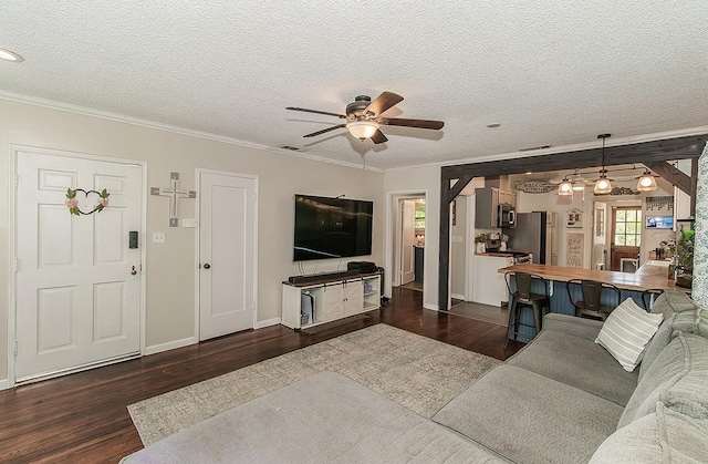 528 W Yale Ave, Fresno, CA 93705 - living room with ornamental molding, a textured ceiling, ceiling fan, dark wood-style floors, and baseboards
