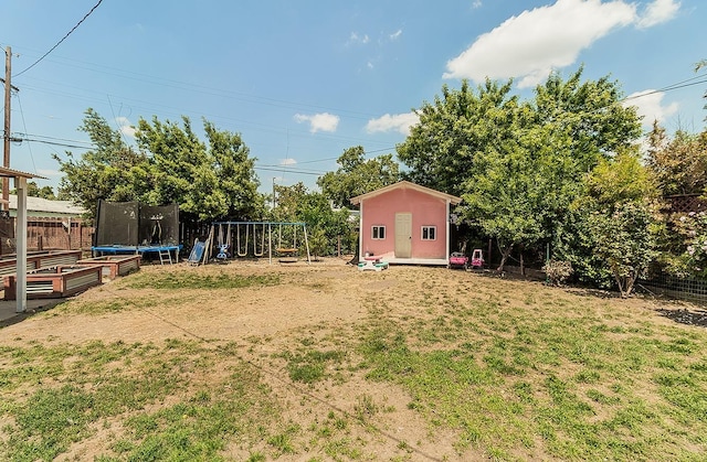 528 W Yale Ave, Fresno, CA 93705 - view of yard with fence, a shed, an outdoor structure, a trampoline, and a playground