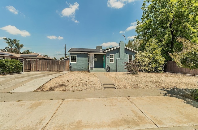 528 W Yale Ave, Fresno, CA 93705 - bungalow-style house with fence, stucco siding, and solar panels