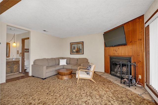 39090 Woodland Rd, Shaver Lake, CA 93664 - living room featuring a fireplace and a textured ceiling