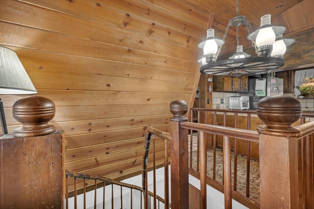 39090 Woodland Rd, Shaver Lake, CA 93664 - staircase featuring wood walls and a chandelier