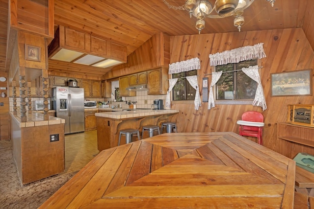 39090 Woodland Rd, Shaver Lake, CA 93664 - dining room with wooden walls, lofted ceiling, and wooden ceiling