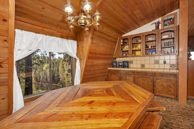 39090 Woodland Rd, Shaver Lake, CA 93664 - dining space with a chandelier, vaulted ceiling, wood walls, and wooden ceiling