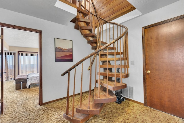 39090 Woodland Rd, Shaver Lake, CA 93664 - staircase with carpet flooring and baseboards