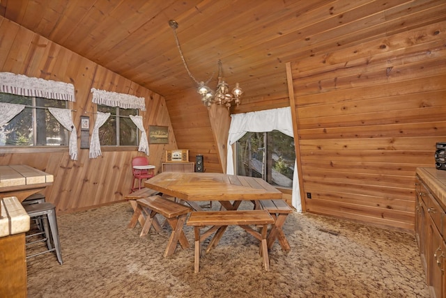 39090 Woodland Rd, Shaver Lake, CA 93664 - dining area featuring carpet flooring, wooden walls, a chandelier, vaulted ceiling, and wood ceiling