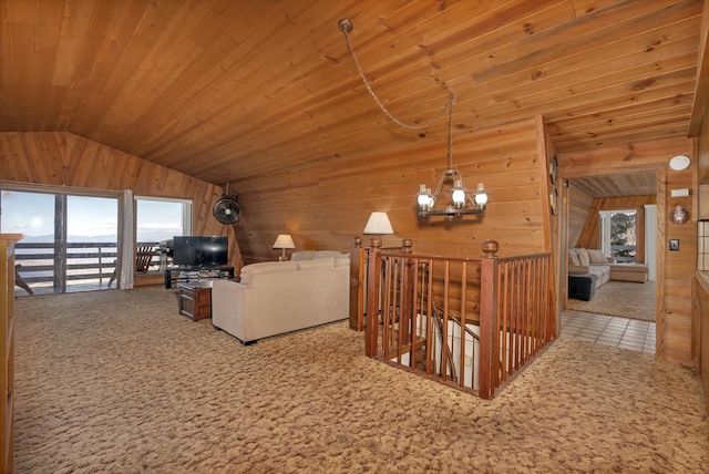 39090 Woodland Rd, Shaver Lake, CA 93664 - living area with wooden walls, vaulted ceiling, carpet, and a chandelier