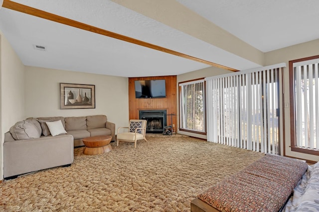 39090 Woodland Rd, Shaver Lake, CA 93664 - carpeted living area featuring healthy amount of natural light, a fireplace, wood walls, and beamed ceiling