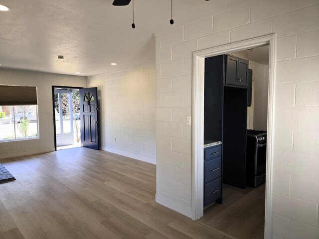 155 E Hampton Way, Fresno, CA 93704 - empty room with recessed lighting, ceiling fan, concrete block wall, and wood finished floors