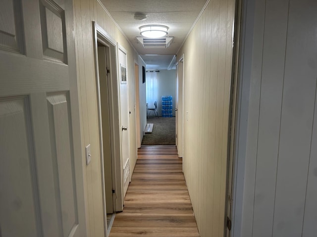 7676 N Fresno St Unit Sp 20, Fresno, CA 93720 - hallway with light wood finished floors, crown molding, and wooden walls