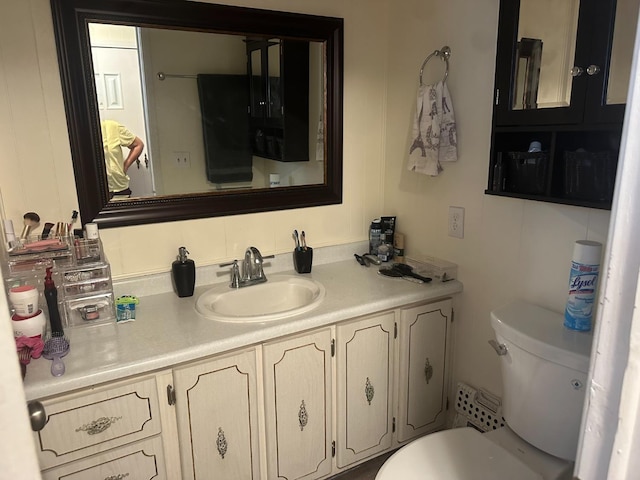 half bathroom with toilet and vanity