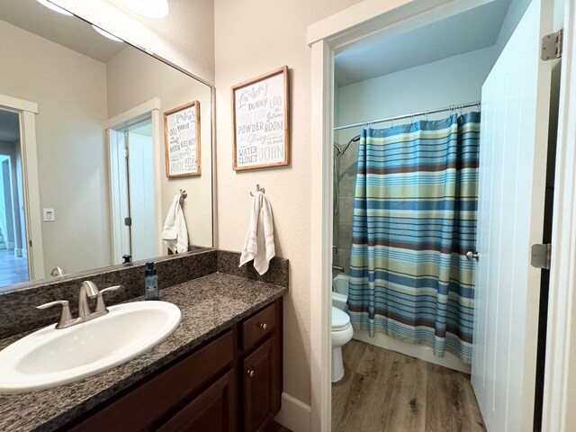 1885 N Whitehorse, Clovis, CA 93619 - bathroom with vanity, toilet, shower / bathtub combination with curtain, and wood finished floors