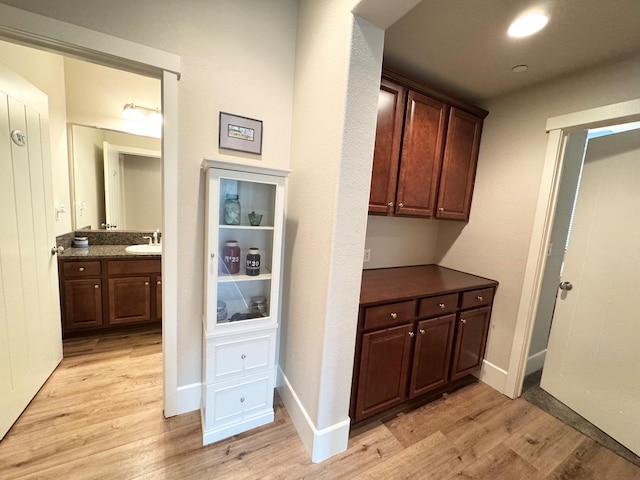 1885 N Whitehorse, Clovis, CA 93619 - corridor with light wood-style floors and a sink