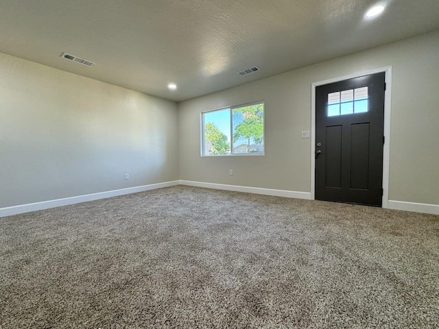 entrance foyer featuring visible vents, baseboards, carpet floors, and recessed lighting