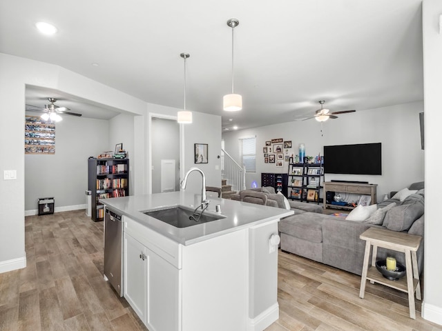 kitchen featuring a sink, ceiling fan, and open floor plan