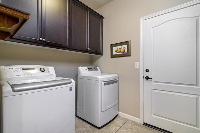 3415 Bellaire Ave, Clovis, CA 93619 - laundry area with washing machine and clothes dryer, cabinet space, light tile patterned floors, and baseboards