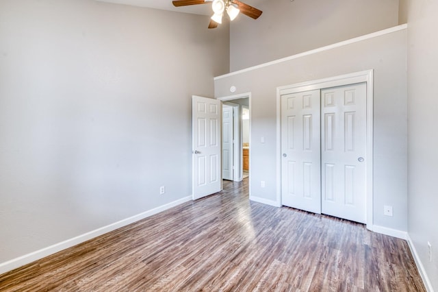 944 N Chapel Hill Ave, Clovis, CA 93611 - unfurnished bedroom with a closet, wood finished floors, a towering ceiling, ceiling fan, and baseboards