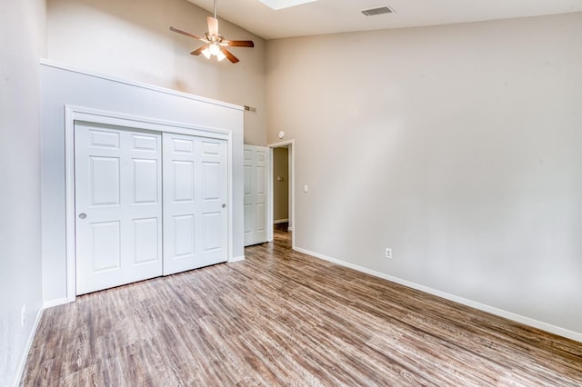 944 N Chapel Hill Ave, Clovis, CA 93611 - unfurnished bedroom with baseboards, high vaulted ceiling, visible vents, and wood finished floors