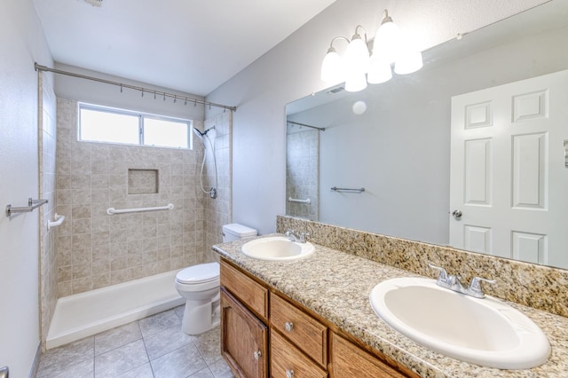 944 N Chapel Hill Ave, Clovis, CA 93611 - full bathroom featuring tile patterned floors, toilet, a tile shower, and a sink