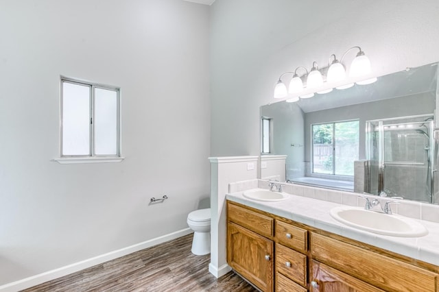 944 N Chapel Hill Ave, Clovis, CA 93611 - bathroom featuring a sink, double vanity, a stall shower, and wood finished floors