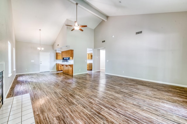 944 N Chapel Hill Ave, Clovis, CA 93611 - unfurnished living room with a ceiling fan, beamed ceiling, high vaulted ceiling, and wood finished floors