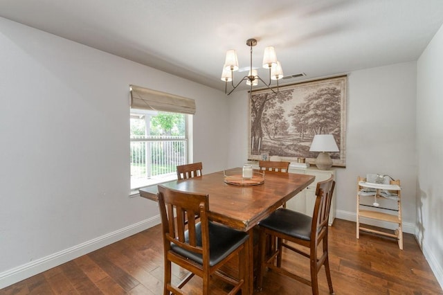 dining area featuring a chandelier, baseboards, visible vents, and wood finished floors