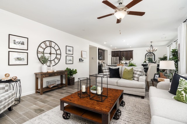 living room featuring wood finish floors, ceiling fan with notable chandelier, baseboards, and recessed lighting