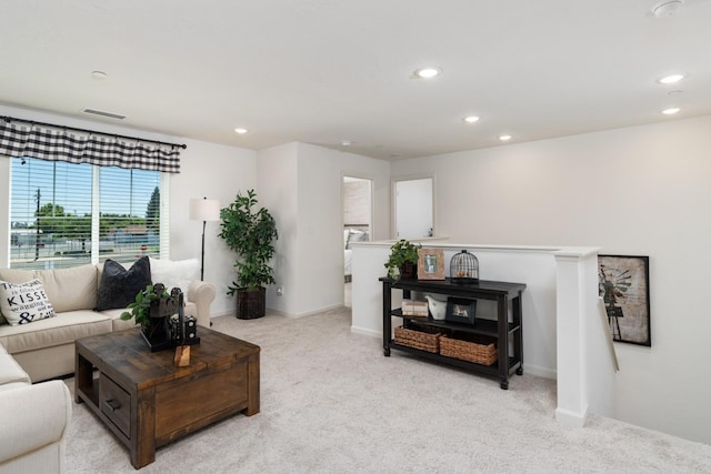 living room featuring light colored carpet, baseboards, visible vents, and recessed lighting