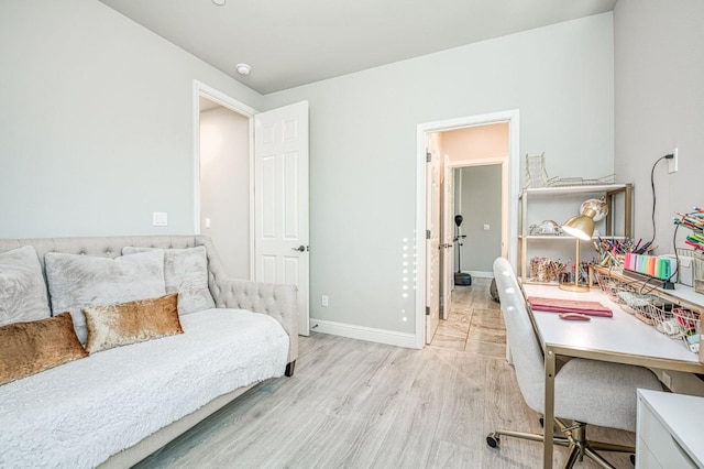 bedroom featuring light wood-style flooring and baseboards