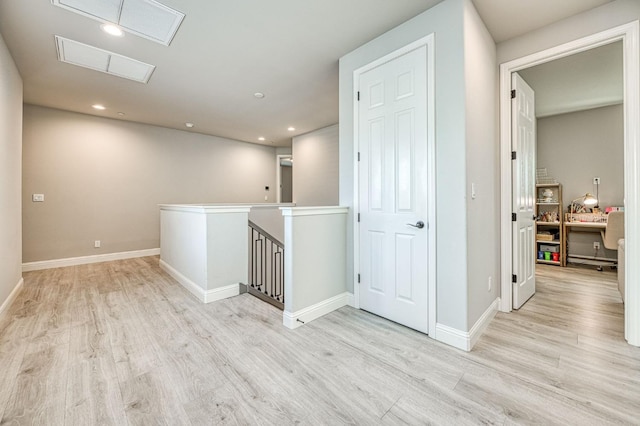 interior space featuring light wood finished floors, baseboards, and recessed lighting