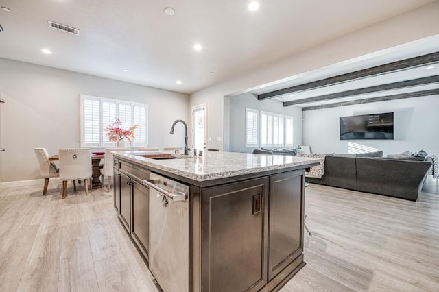 kitchen with light wood finished floors, a sink, stainless steel dishwasher, visible vents, and recessed lighting