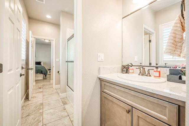 ensuite bathroom featuring ensuite bath, visible vents, vanity, and a shower with shower door
