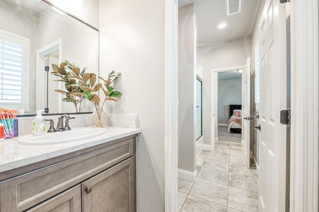 ensuite bathroom featuring connected bathroom, visible vents, baseboards, marble finish floor, and vanity