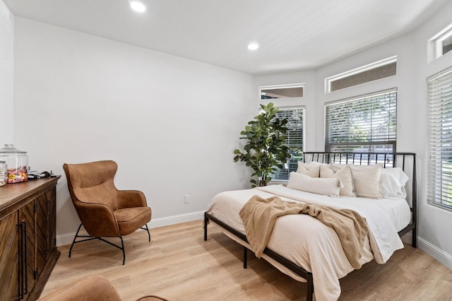 bedroom featuring light wood finished floors, baseboards, and recessed lighting