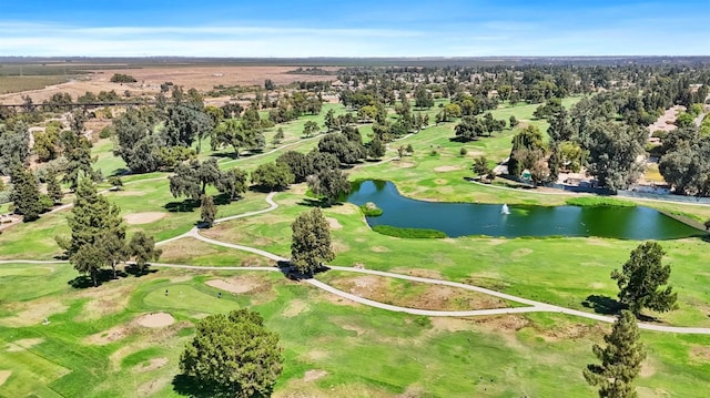 birds eye view of property with a water view and golf course view