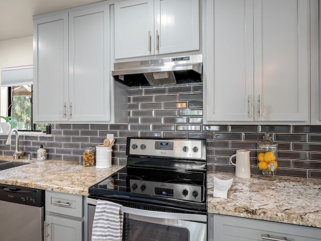 17324 Bonita Rd, Madera, CA 93636 - kitchen featuring light stone countertops, under cabinet range hood, a sink, decorative backsplash, and stainless steel appliances
