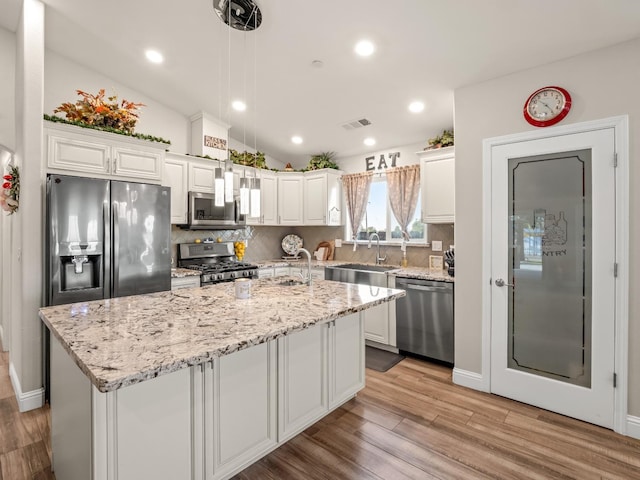 17324 Bonita Rd, Madera, CA 93636 - kitchen with visible vents, a sink, decorative backsplash, stainless steel appliances, and white cabinets