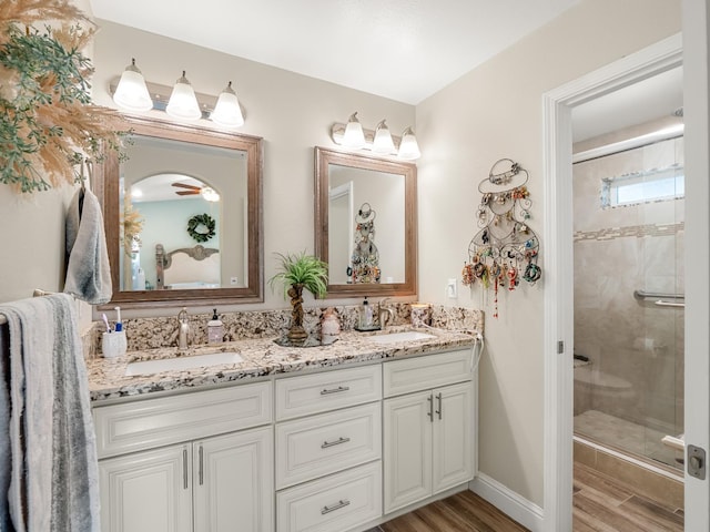 17324 Bonita Rd, Madera, CA 93636 - bathroom featuring a sink, double vanity, a shower stall, and wood finished floors