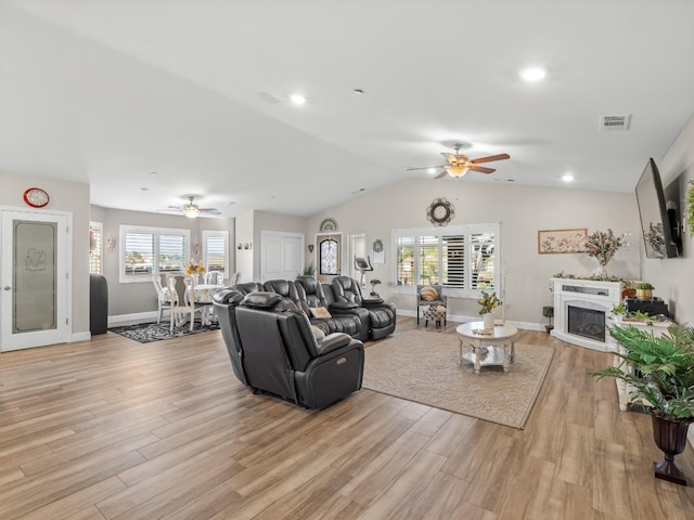 17324 Bonita Rd, Madera, CA 93636 - living room with a glass covered fireplace, visible vents, light wood-style flooring, and ceiling fan
