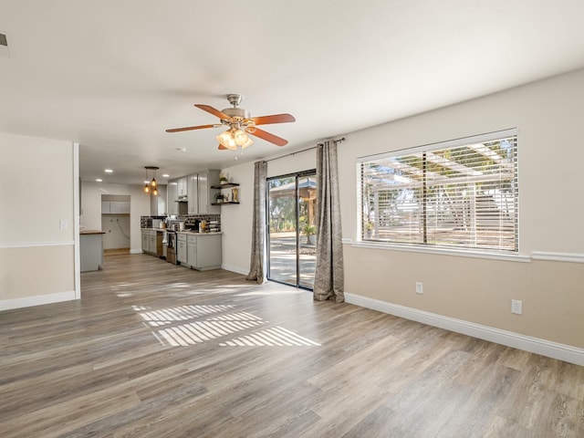 17324 Bonita Rd, Madera, CA 93636 - unfurnished living room featuring baseboards and light wood finished floors