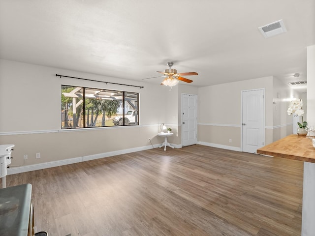 17324 Bonita Rd, Madera, CA 93636 - unfurnished living room featuring baseboards, visible vents, wood finished floors, and a ceiling fan