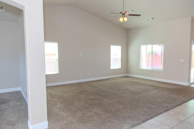 spare room with baseboards, ceiling fan, visible vents, and light colored carpet
